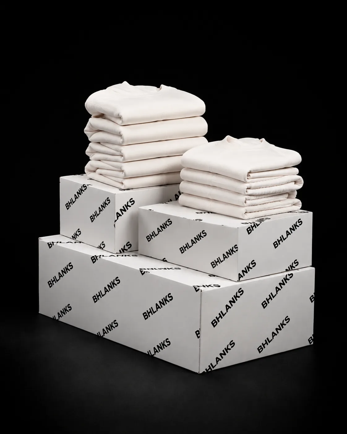 Folded finished garments beside labeled cartons